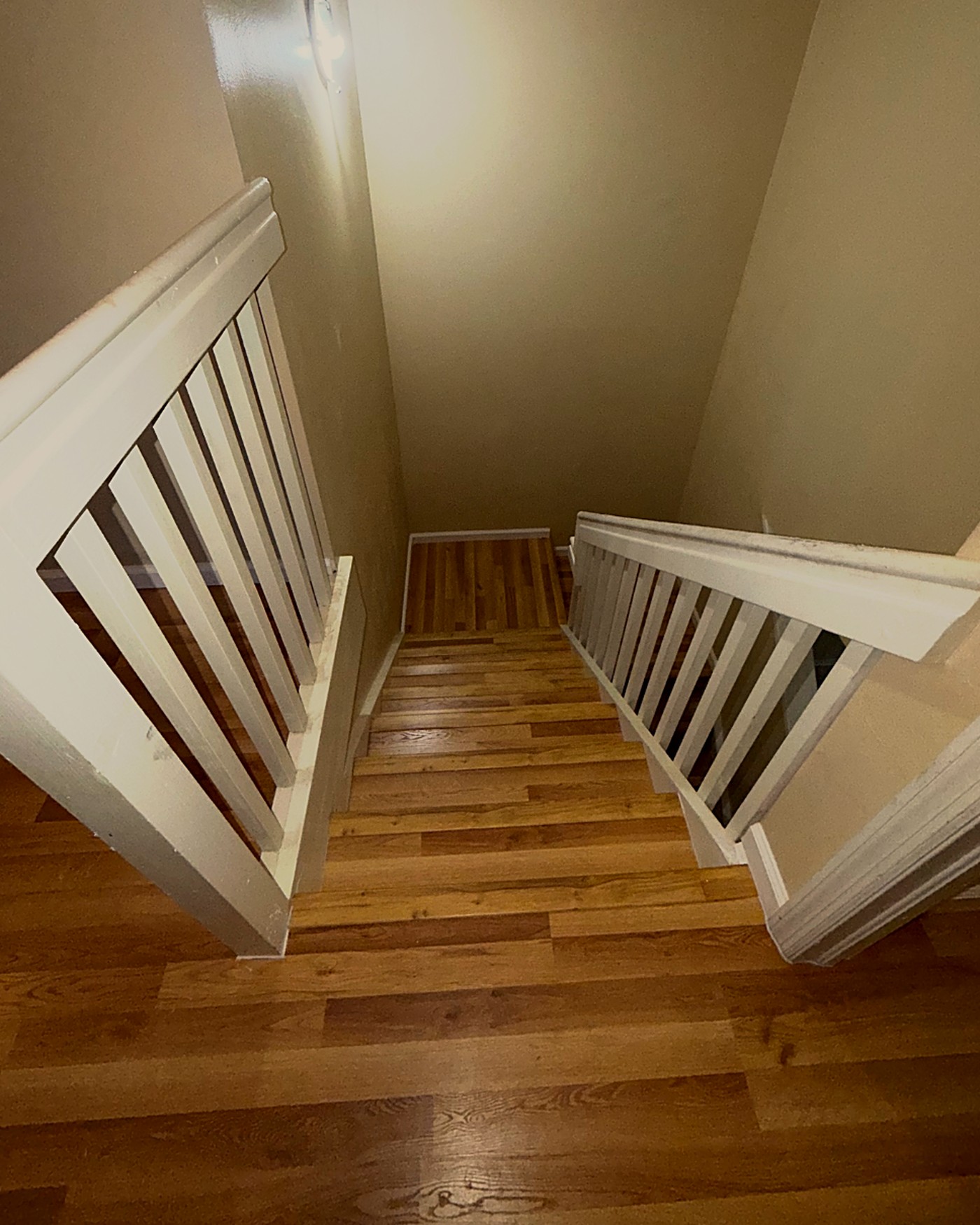 Same staircase after installing oak-look luxury vinyl plank flooring